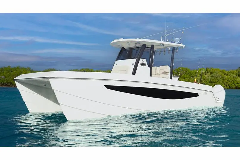 White powerboat navigating through turquoise water near lush green mangroves, showcasing sleek design and fishing equipment.